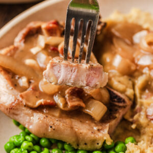 tender pork chops cooked and served on a plate.