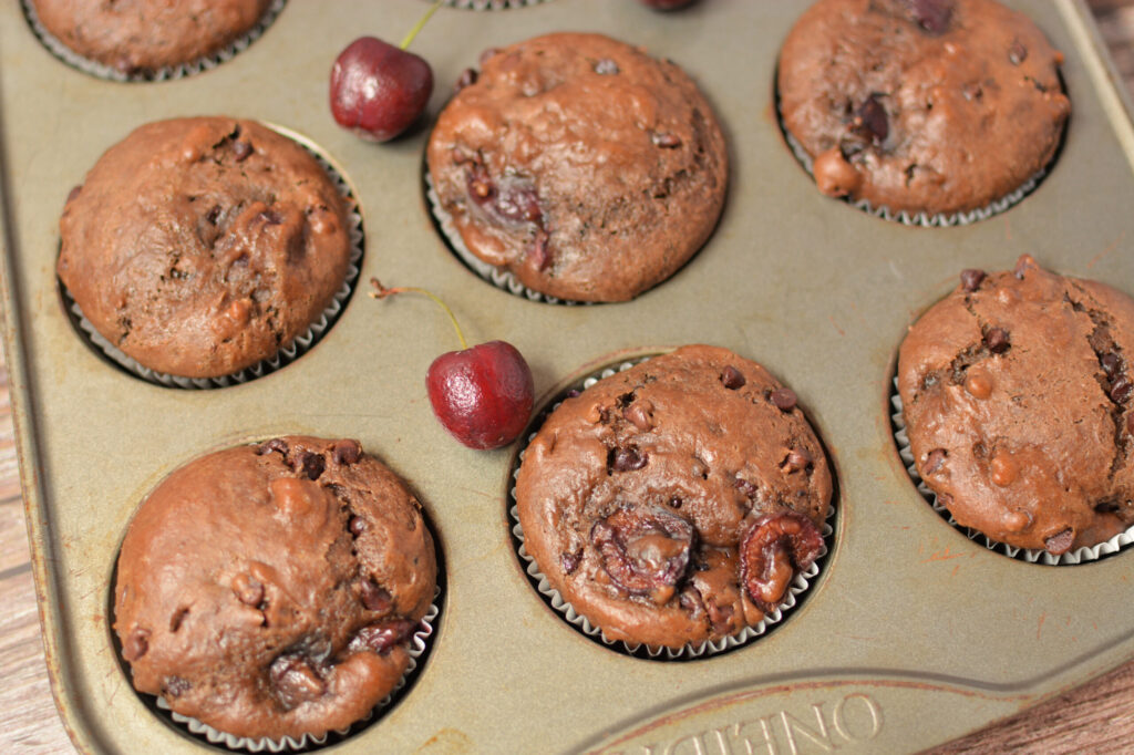 fluffy and chocolate filled muffins with cherry bits throughout.