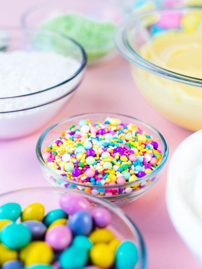 sprinkles, candies, and Easter decorations in bowls.