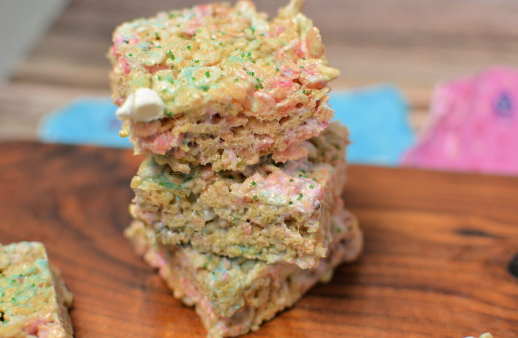 a stack of Easter Rice Krispy bars on a cutting board.