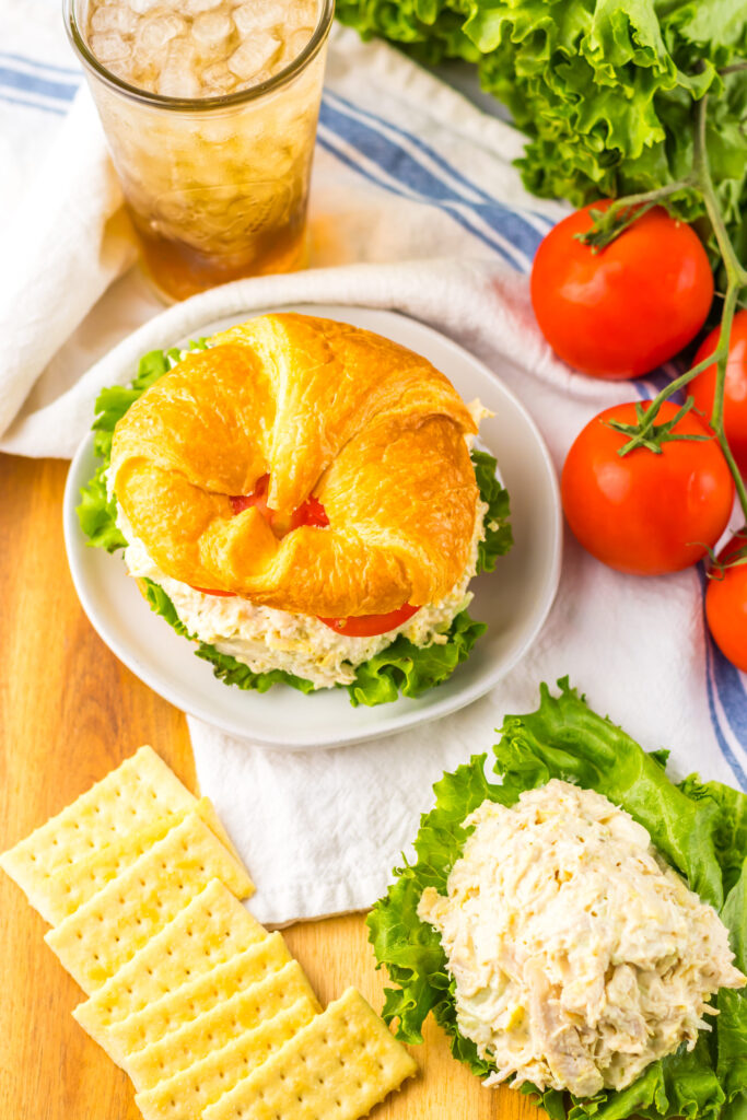 a chicken salad sandwich made with simple ingredients and lettuce/tomato.