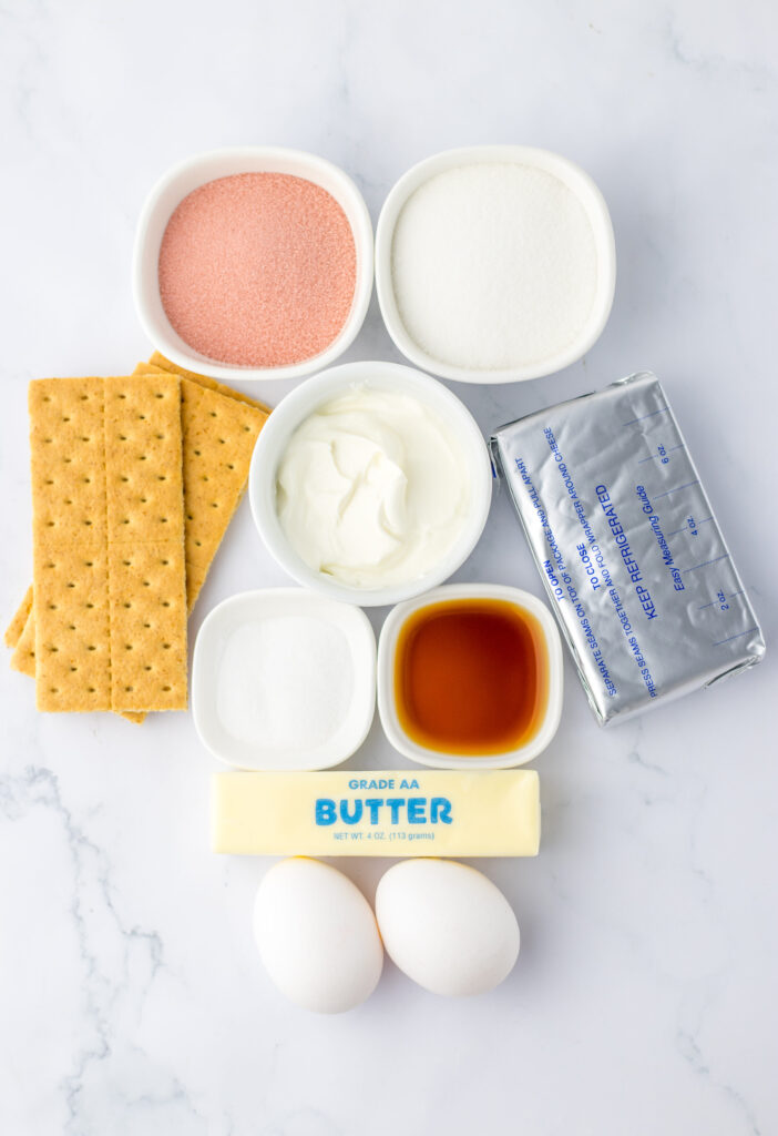 all the ingredients needed to make mini cheesecakes flavored with strawberry.