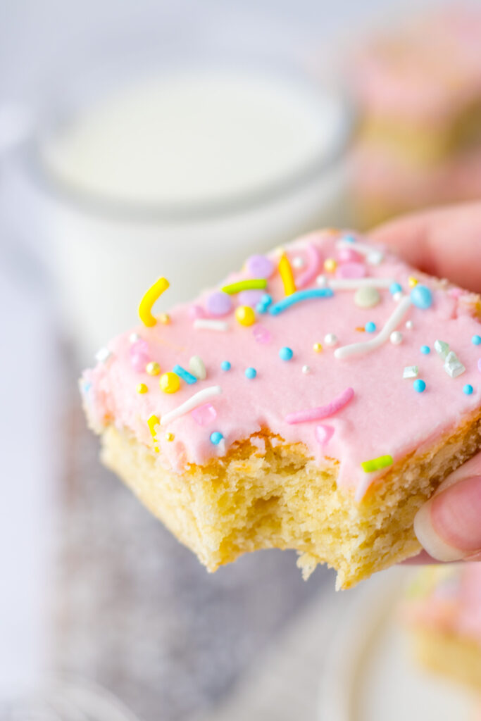 a piece of sugar cookie bars ready to eat.