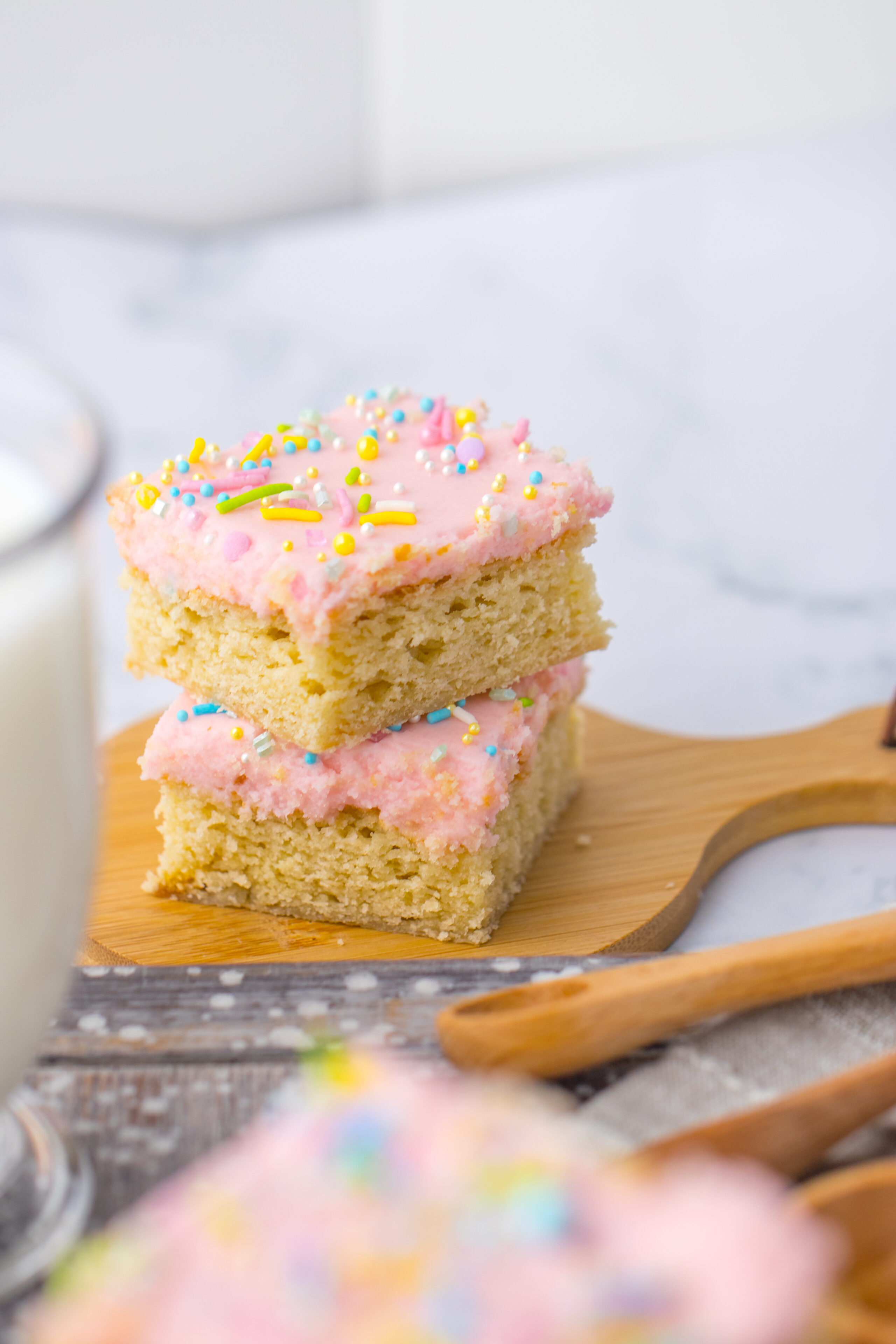 a stack of sugar cookie bars with homemade frosting on top.
