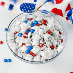 4th of july themed muddy buddy cereal in a bowl.