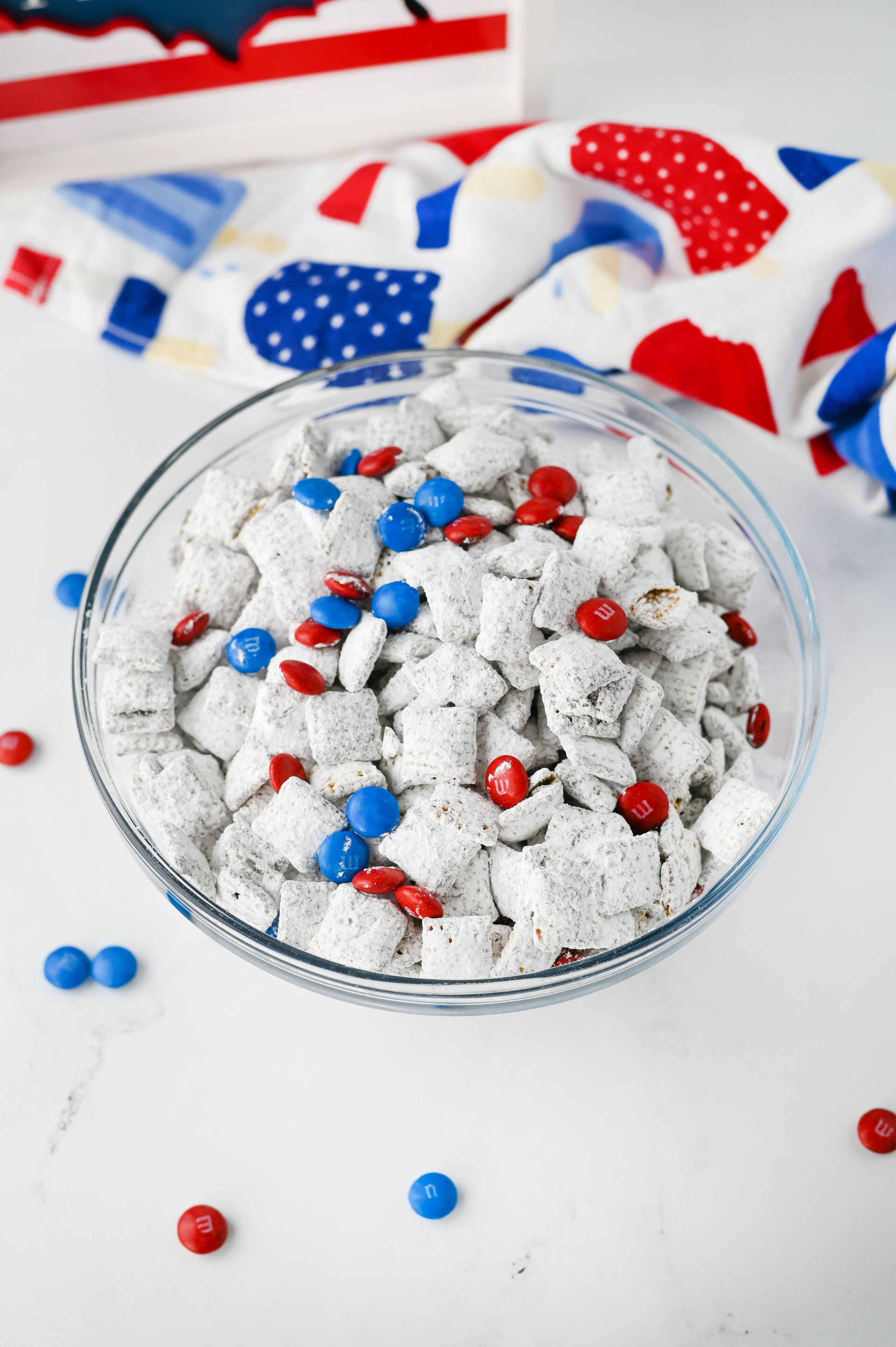 Fourth of July colored puppy chow in a glass bowl.