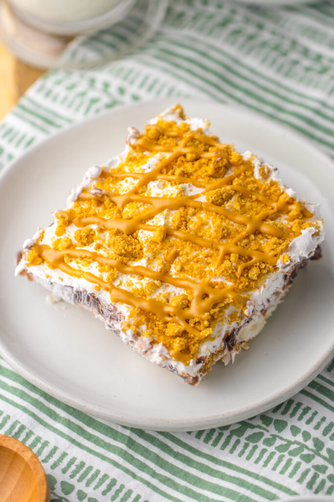 a no-bake layered dessert made with whipped topping, pudding, and cookies.