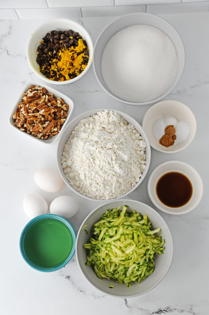 all the ingredients needed to make a quick bread with zucchini and chocolate chips.