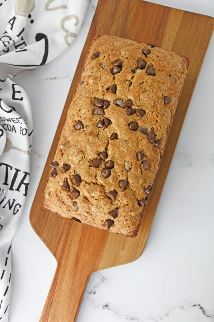 a quick bread loaf on a wood cutting board.