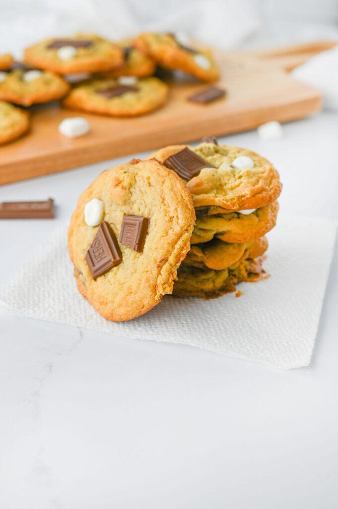 a stack of fresh cookies on a piece of parchment paper.