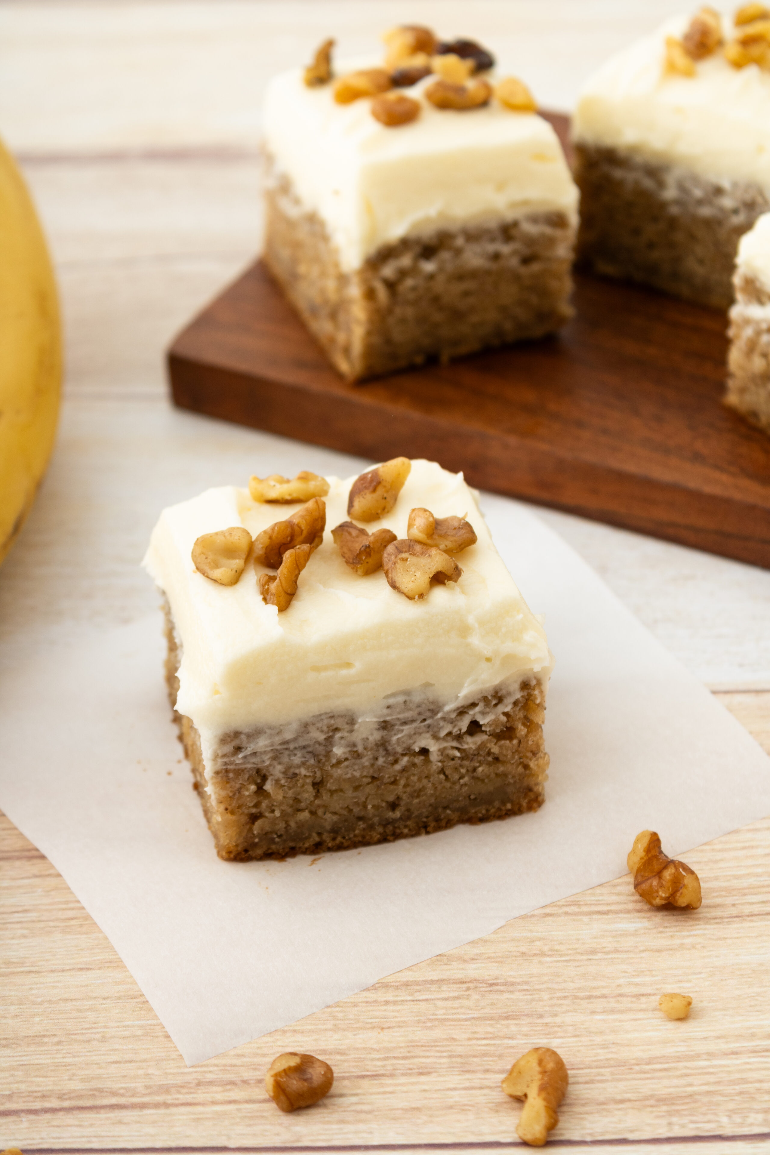 a piece of banana bread bar topped with cream cheese frosting.