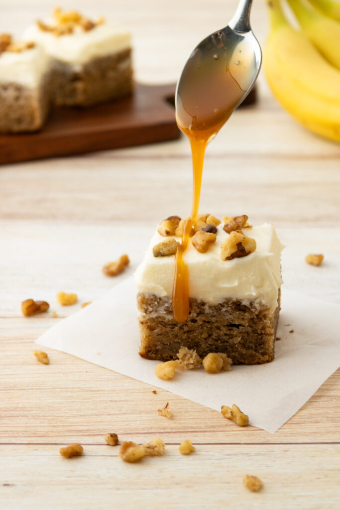 drizzling caramel on top of a banana bar ready to serve.