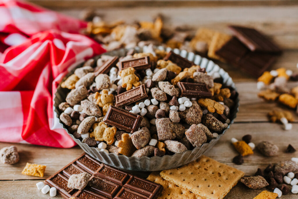 S'mores muddy buddies in a metal tin ready to serve.
