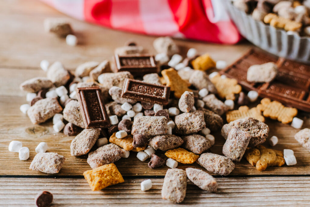 chocolate nutella coated chex cereal with powdered sugar and graham crackers.