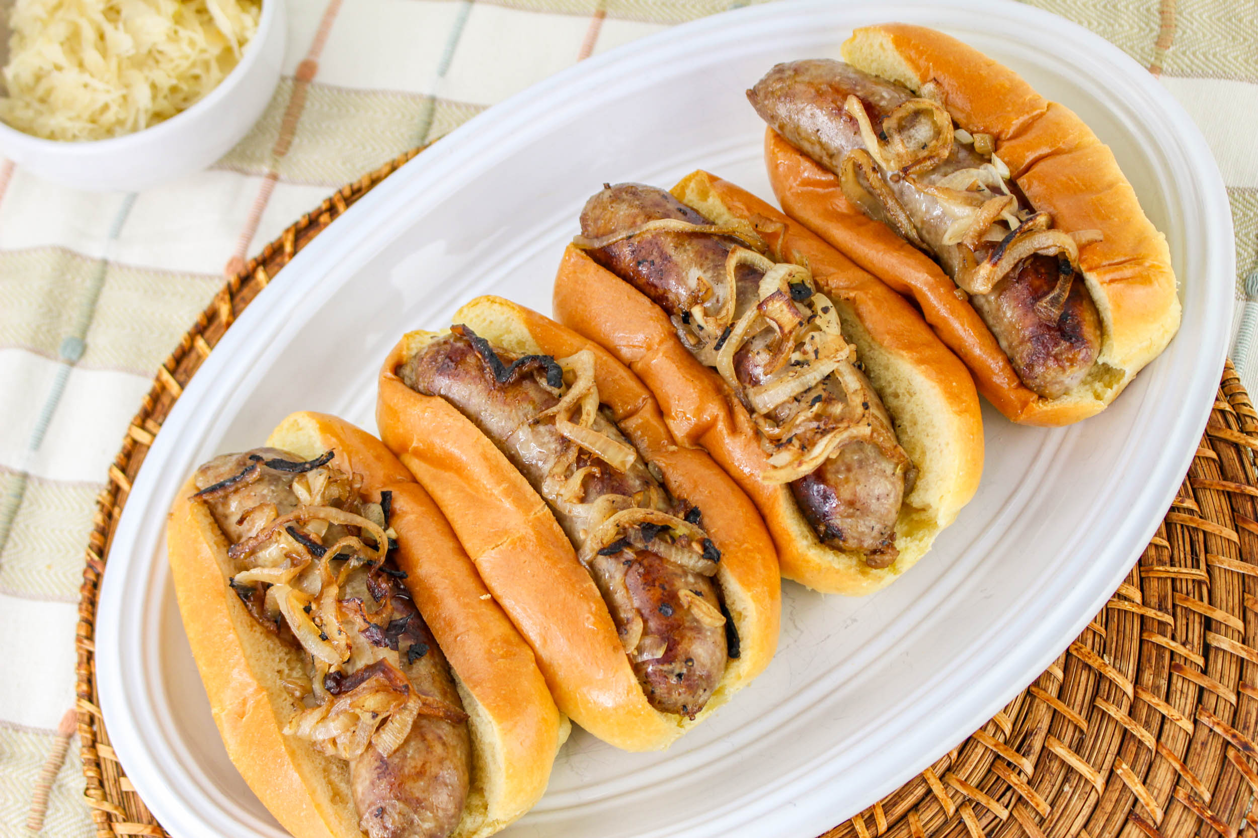 oven cooked sausages on hot dogs buns.
