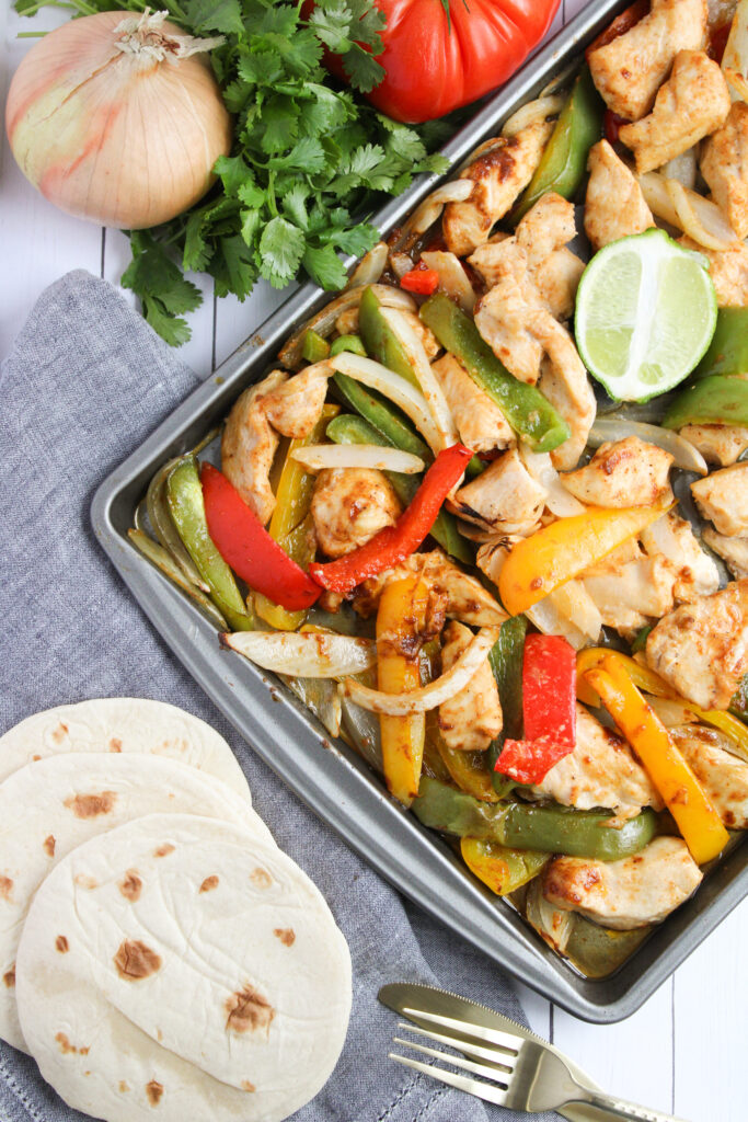 chicken fajitas cooked on a sheet pan.