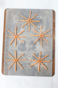 pretzel rods formed into a spider web.