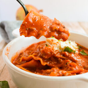 a spoon taking a bite of cheesy soup.