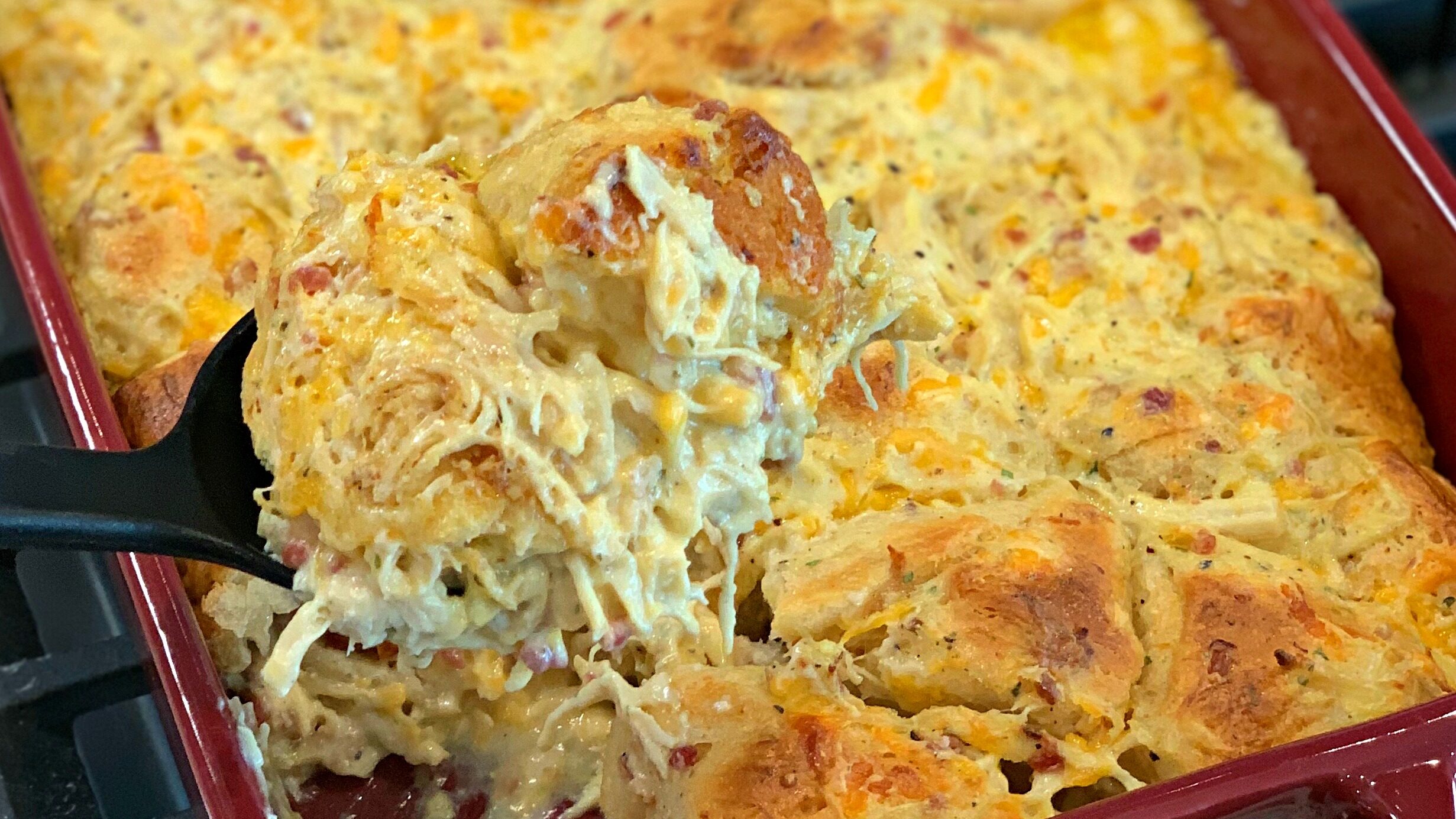 Shredded chicken, bacon bits, biscuit pieces, and cheese combined into a casserole