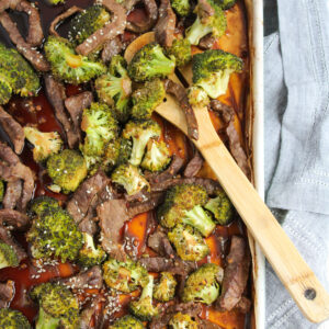 a one pan meal ready to serve via wooden spoon.