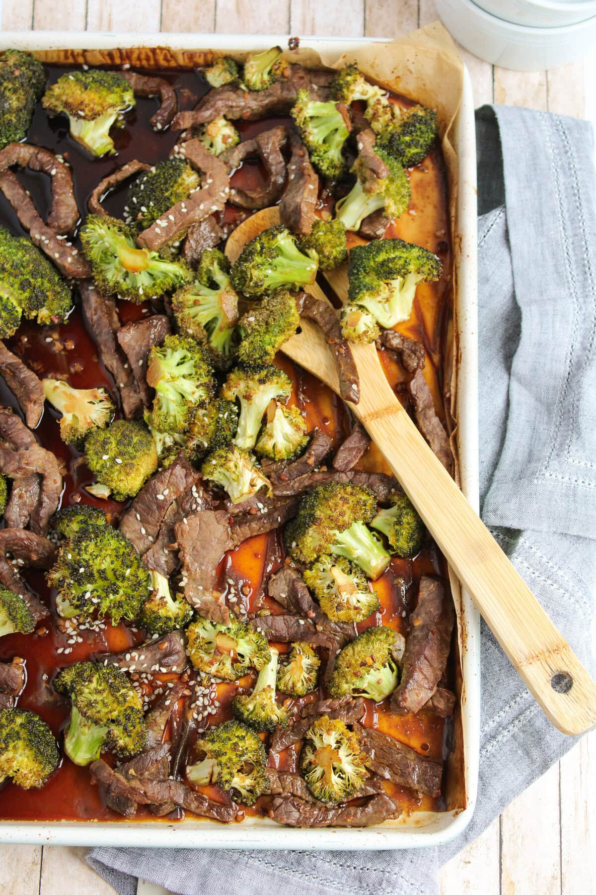 a one pan meal ready to serve via wooden spoon.