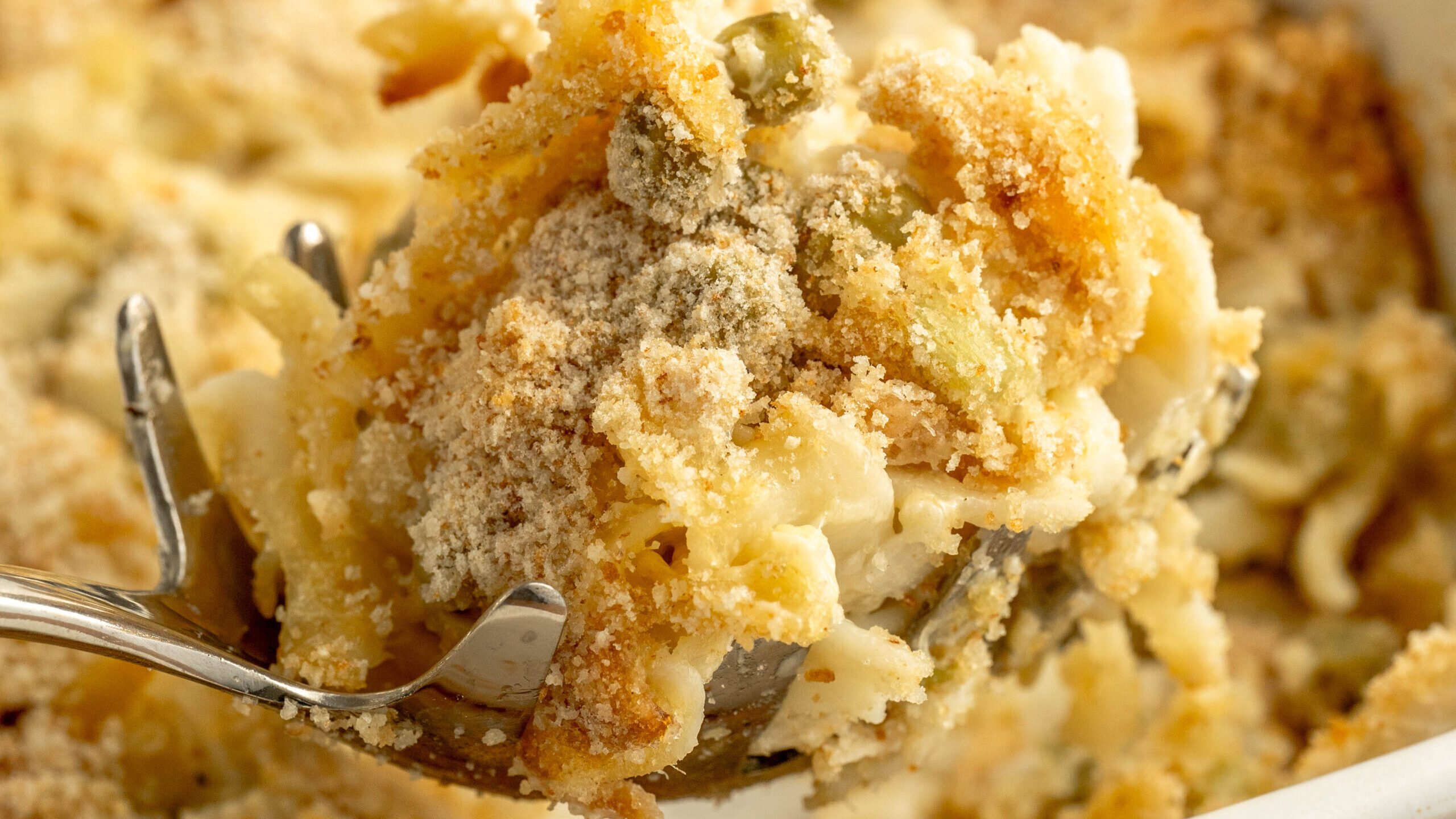 a spoon taking a serving out of a casserole.