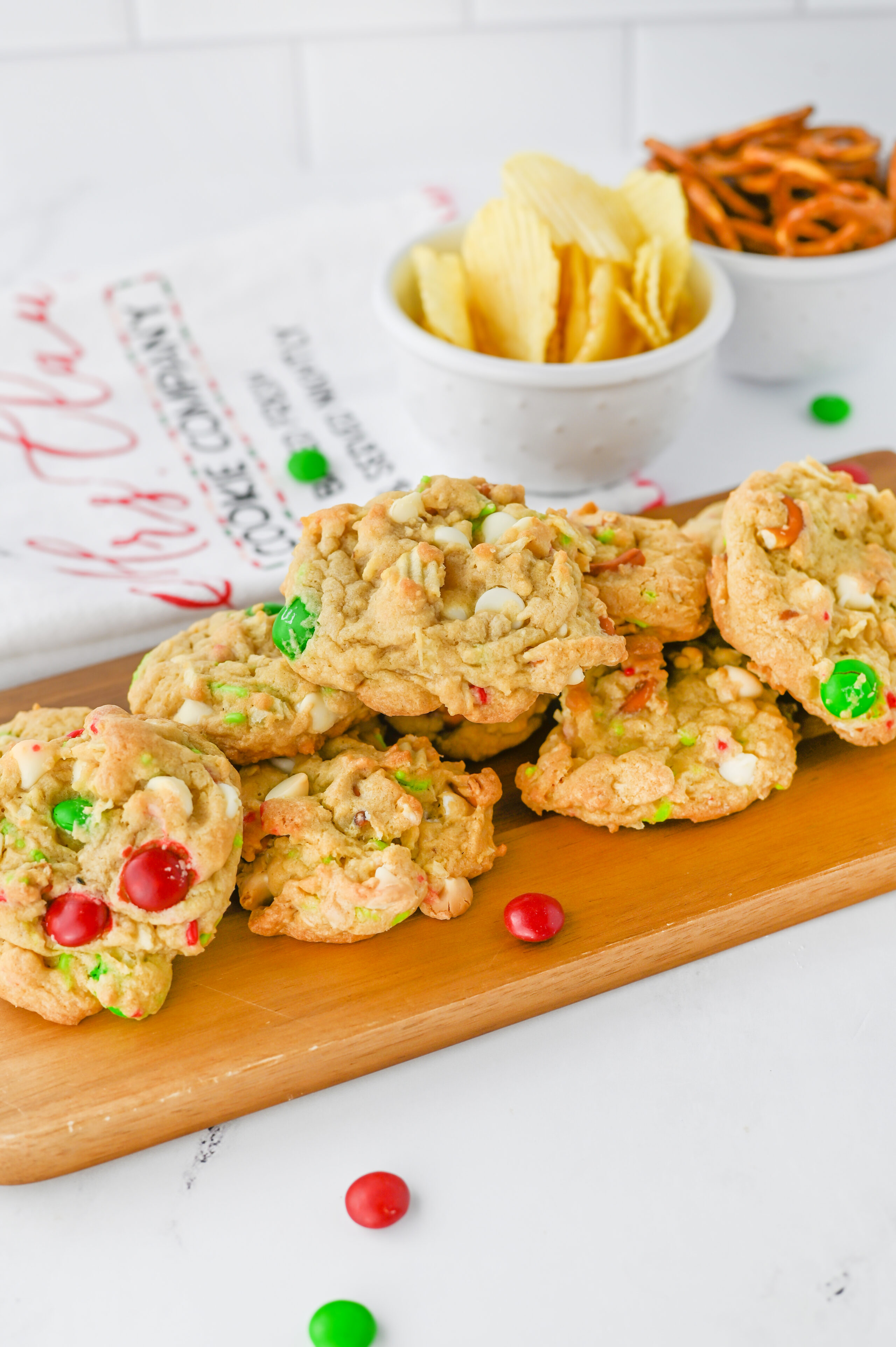 Christmas Kitchen Sink Cookies on a wood serving board.