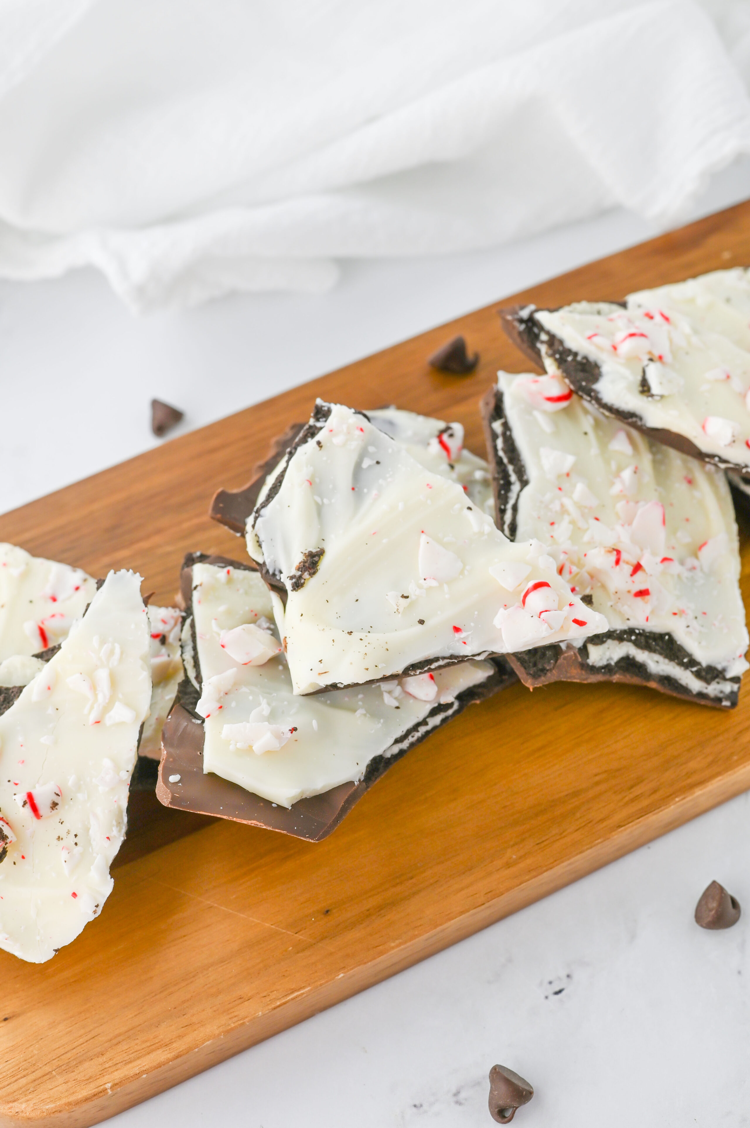 Oreo peppermint bark on a wood serving board.