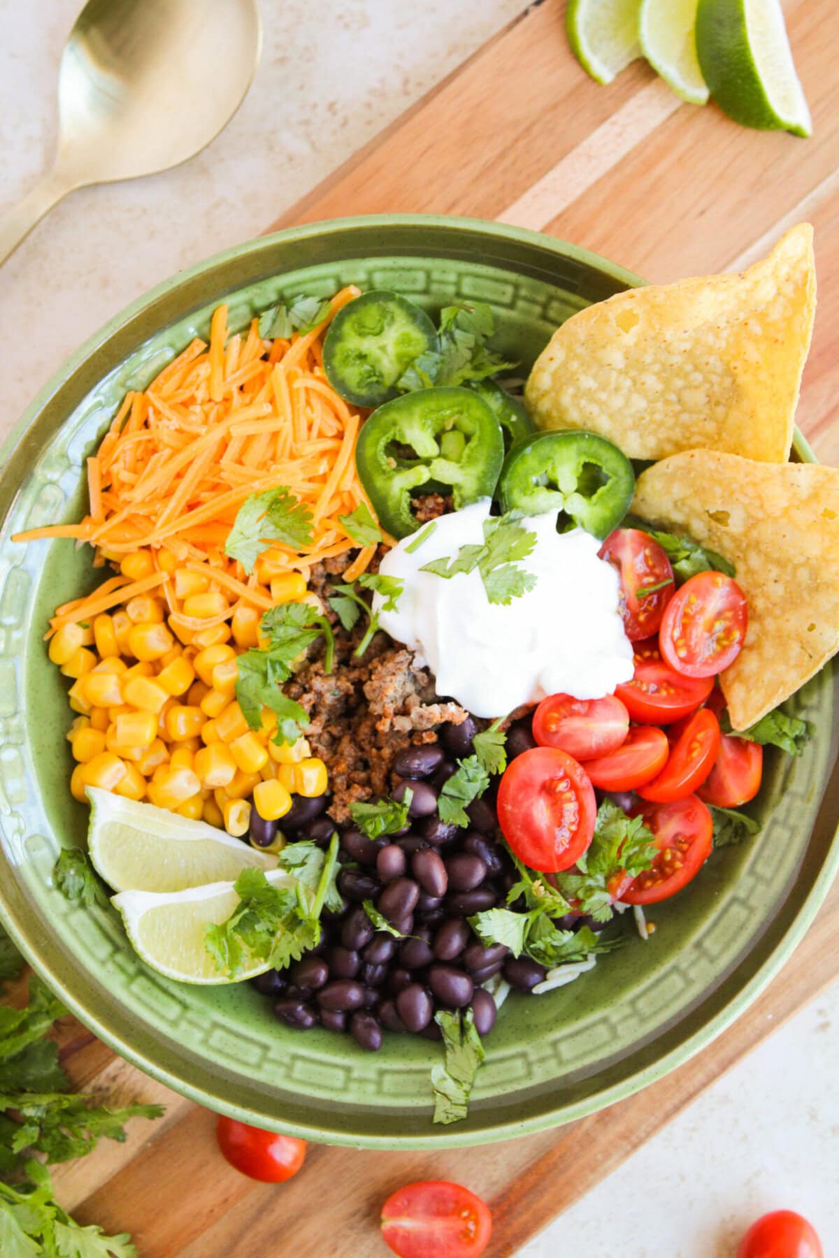 Protein, rice, and veggies in a green bowl for meal prep.