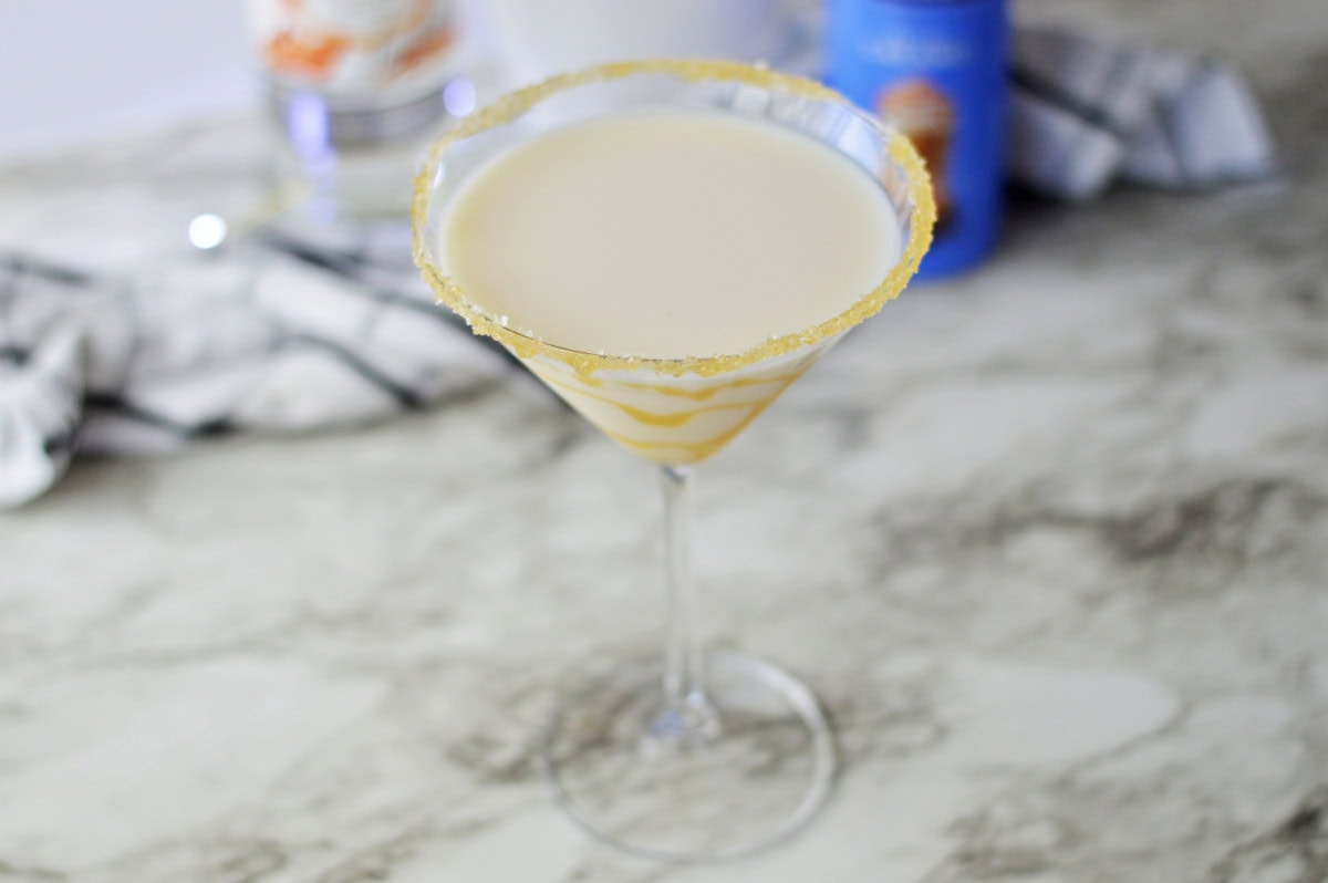a salted caramel rimmed martini glass with salted caramel martini ready to enjoy.