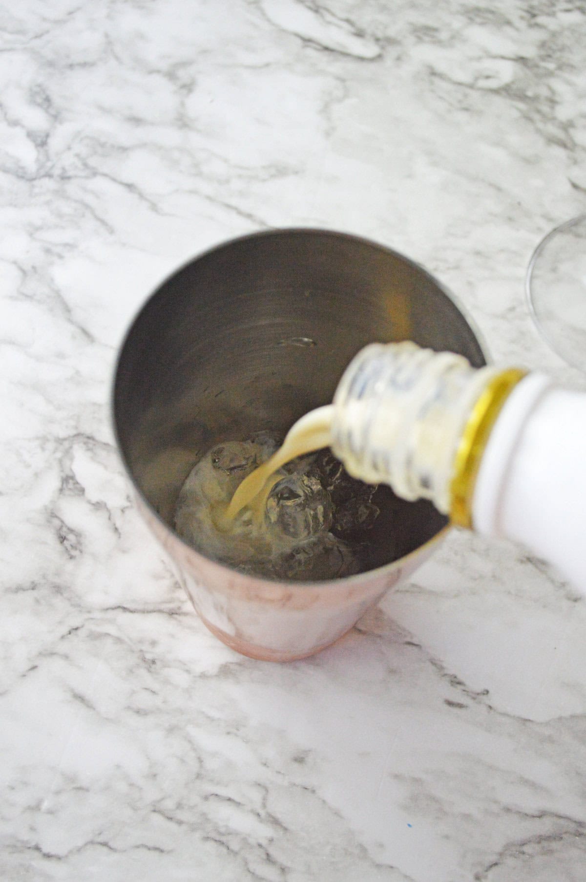 Rumchata added to caramel vodka and ice in a cocktail shaker.