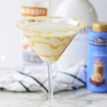 a creamy salted caramel martini drizzled with caramel syrup inside.