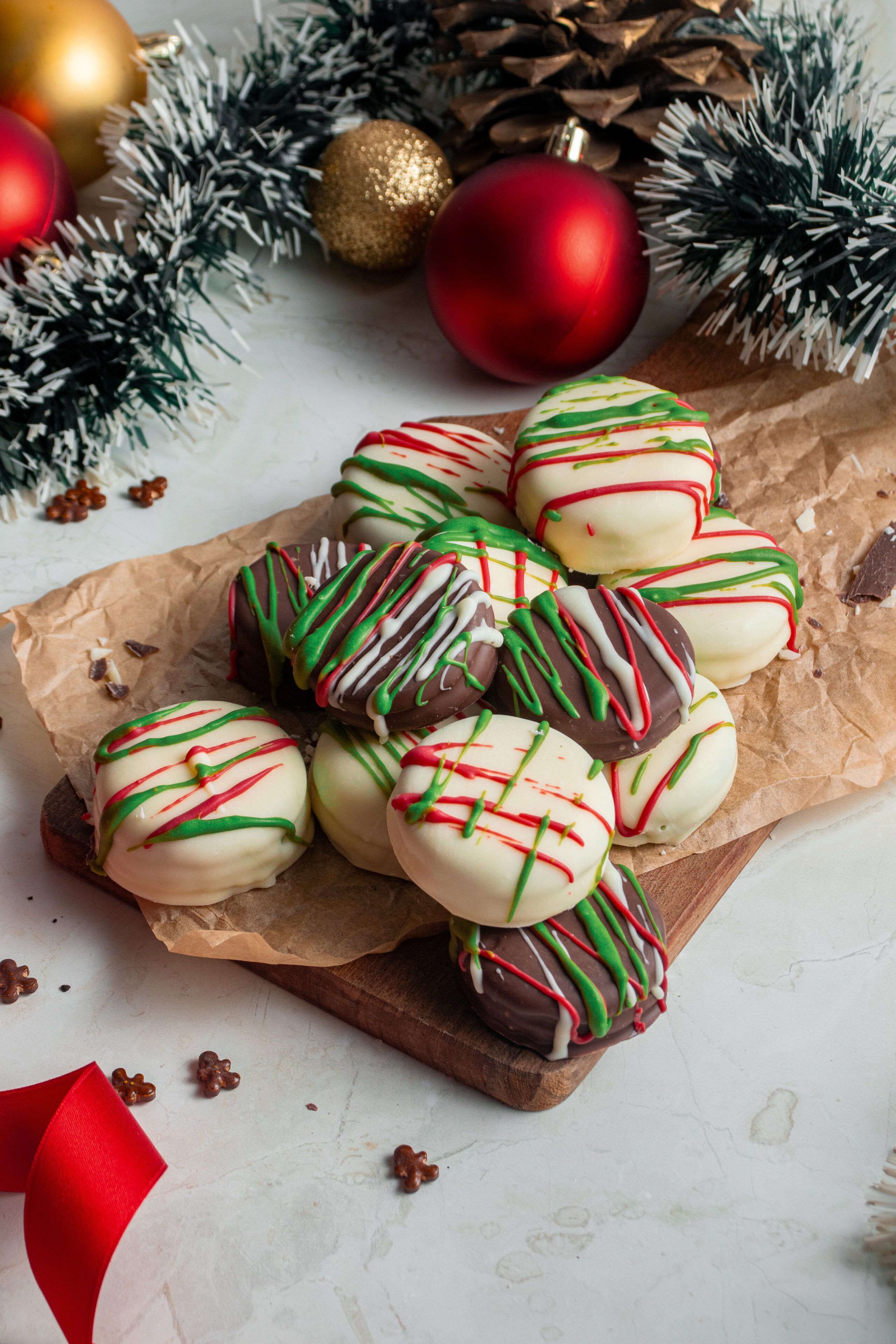 chocolate dipped Oreos on a wood board.