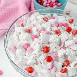 Cupid themed muddy buddies in a glass bowl.