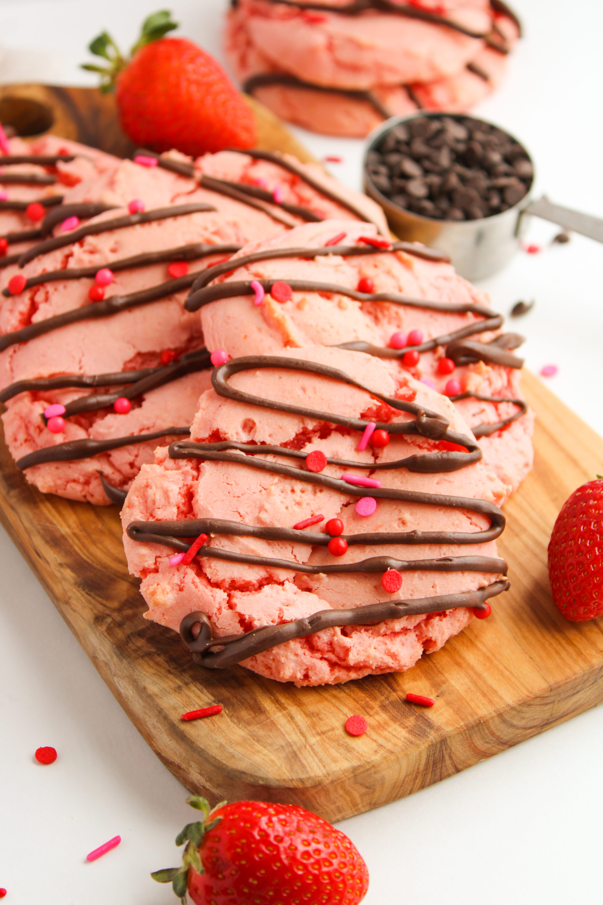 chocolate covered strawberry cookies on a wood board.