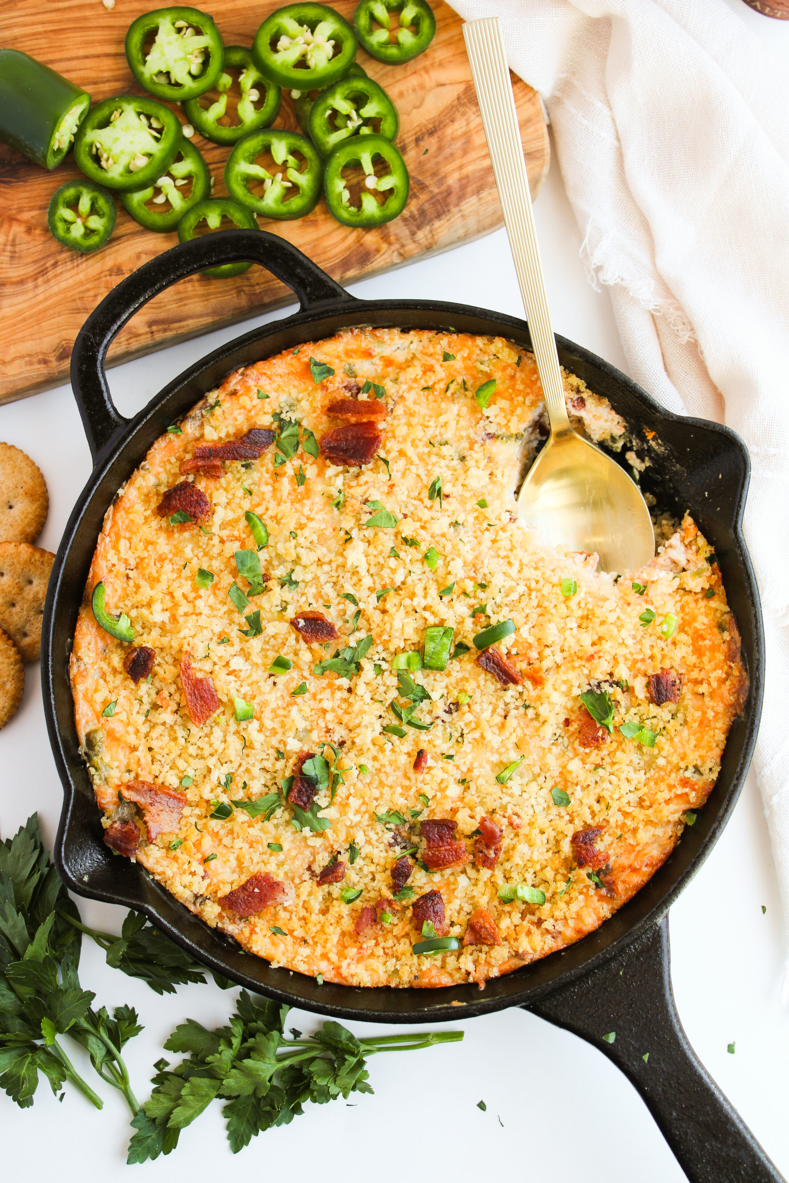 cheesy jalapeno popper dip in a cast iron skillet.