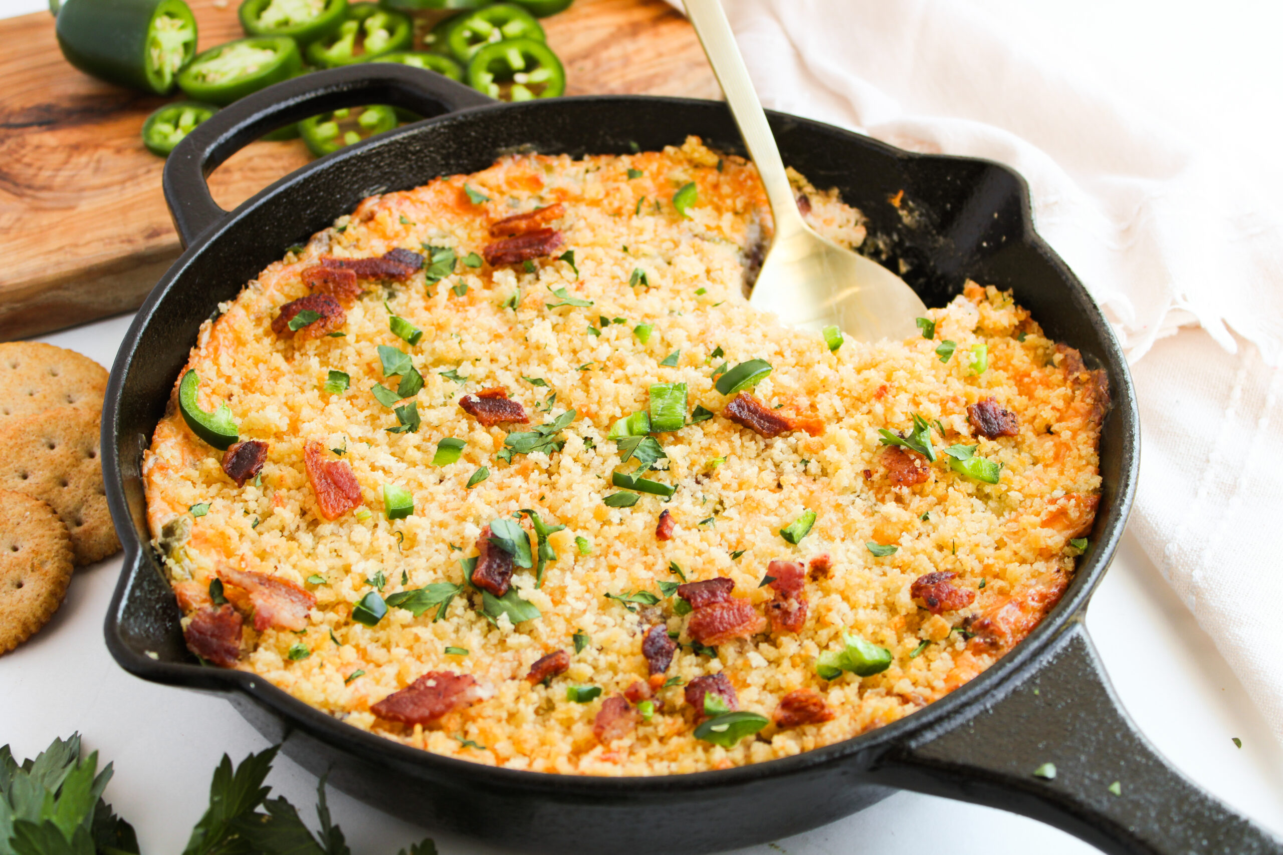 cheesy dip made in a cast iron skillet with peppers.