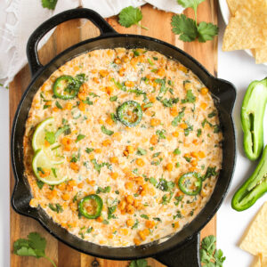 Elote corn dip in a cast iron skillet.