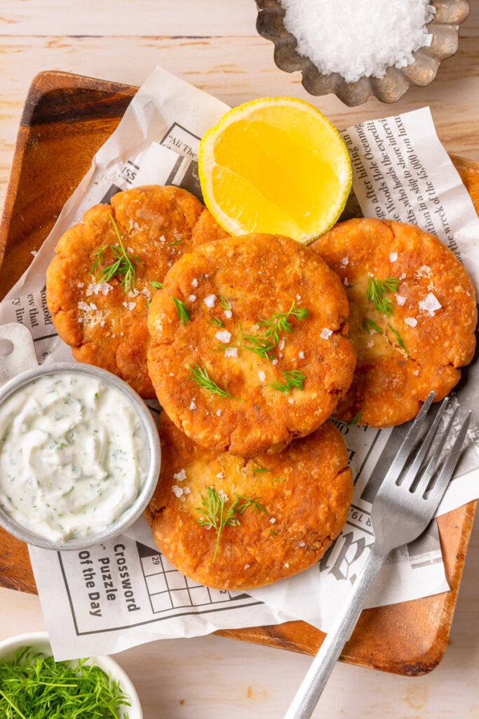 a seafood old fashioned recipe made with simple ingredients and served on a tray with lemon wedges.