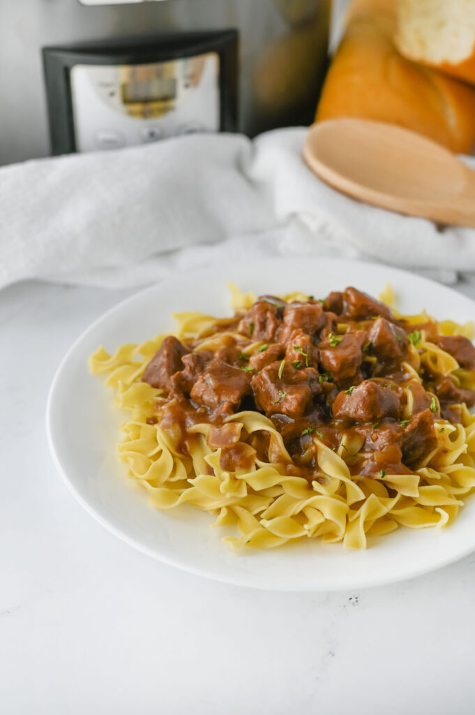 a tender meat dish made in the slow cooker and served over pasta.