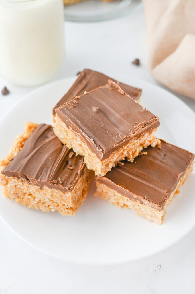 chocolate peanut butter no bake bars sliced on a plate.