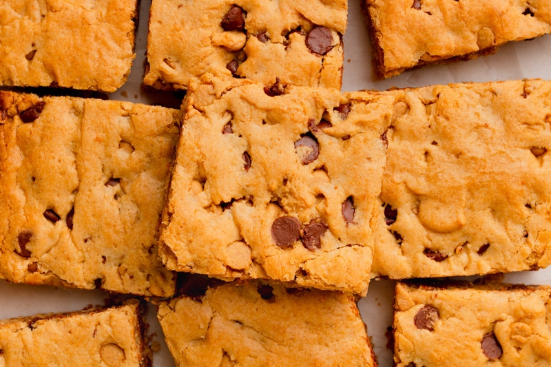 sliced servings of dessert on a piece of parchment paper.