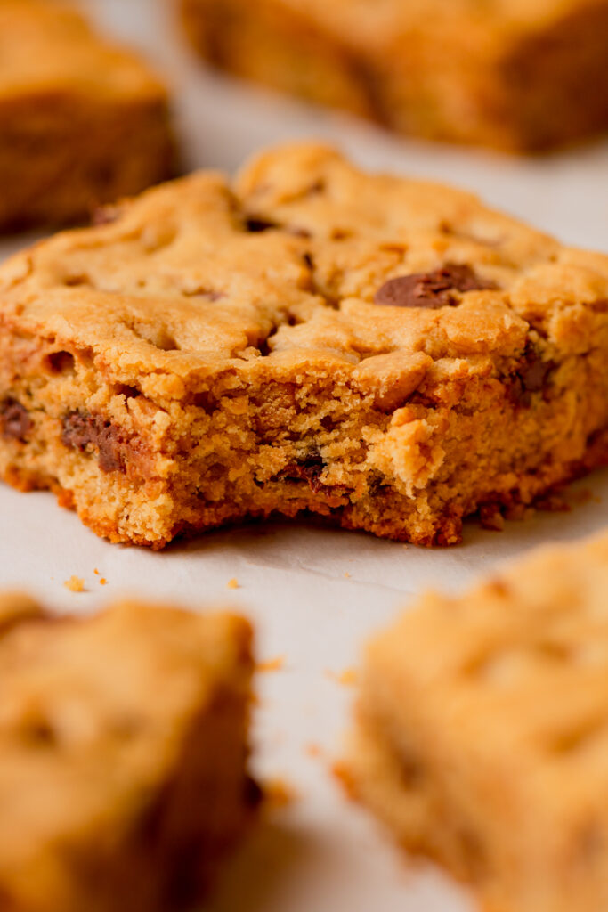 a bite taken out of a chocolate peanut butter cookie bar.