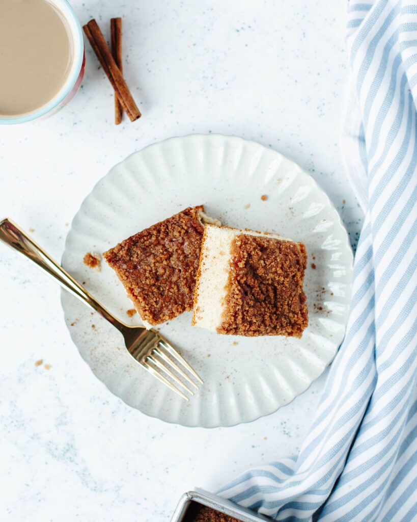 a white breakfast plate with two pieces of cinnamon streusel cake.