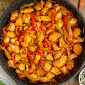 a skillet with spicy chicken and veggies.