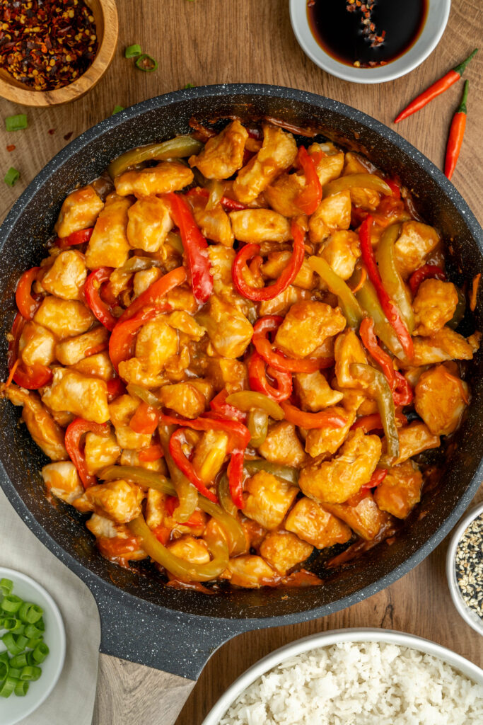 a skillet with spicy chicken and veggies.