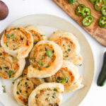 creamy roll ups on a white plate ready to serve.
