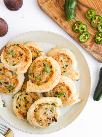 creamy roll ups on a white plate ready to serve.
