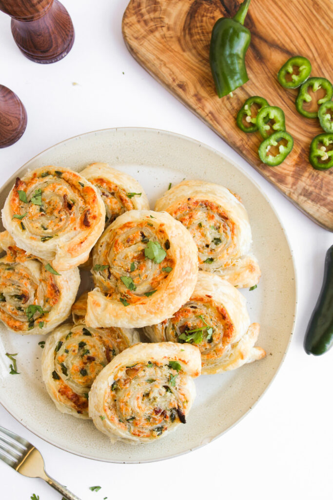 creamy roll ups on a white plate ready to serve. 