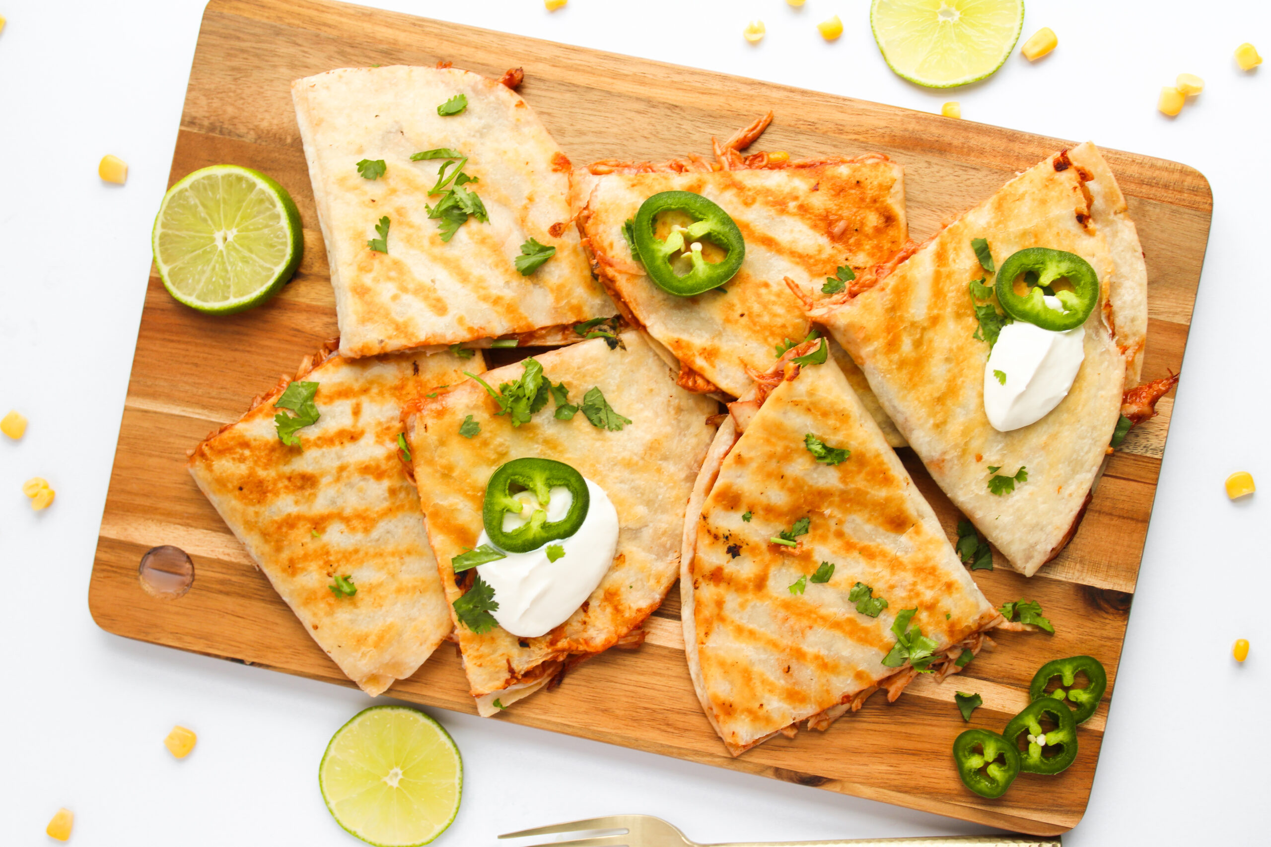 stuffed tortillas toasted and served on a wood cutting board.